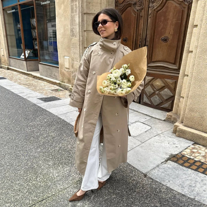 Women’s maxi trench coat with high stand-up collar, double-breasted button placket & waist belt Mune Fashion