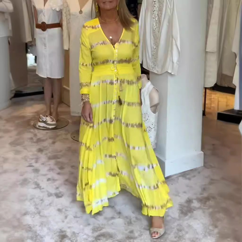 Women's flowing maxi dress with V-neck, full button placket, fitted tassel belt, and pleated skirt Mune Fashion