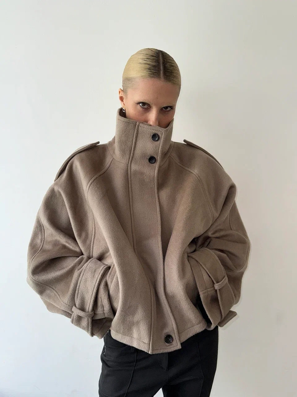 Ladies short cut oversized wool jacket with high stand-up collar, shoulder flaps and adjustable sleeve straps Mune Fashion