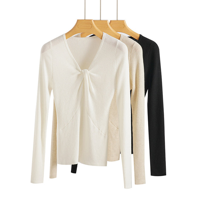 Women's fine-knit top with V-neck, twist detail, and fitted silhouette Mune Fashion