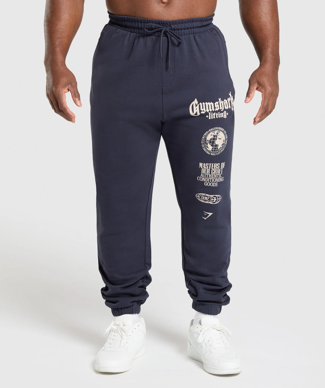 Men's tapered cotton fleece sweatpants with an elastic drawstring waistband, ribbed leg openings, and large logo print Mune Fashion