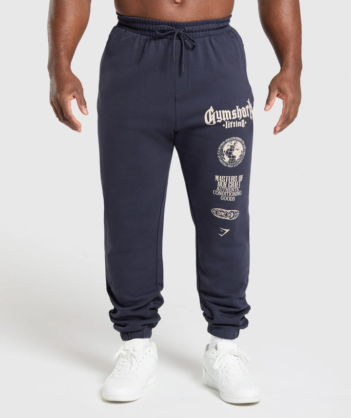 Men's tapered cotton fleece sweatpants with an elastic drawstring waistband, ribbed leg openings, and large logo print Mune Fashion