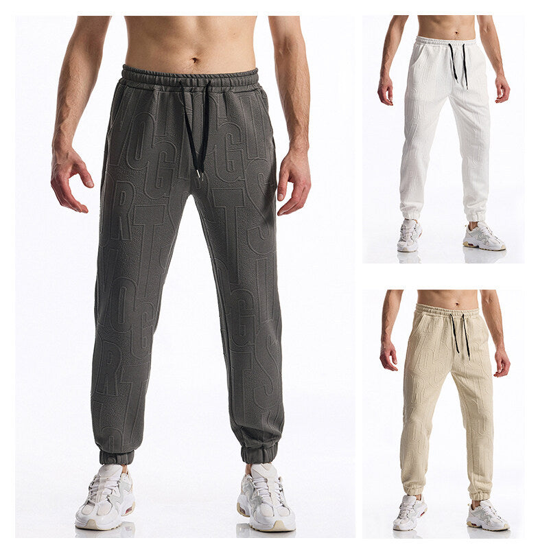 Men's jogging pants with elastic waistband, drawstring, and embossed all-over logo relief Mune Fashion