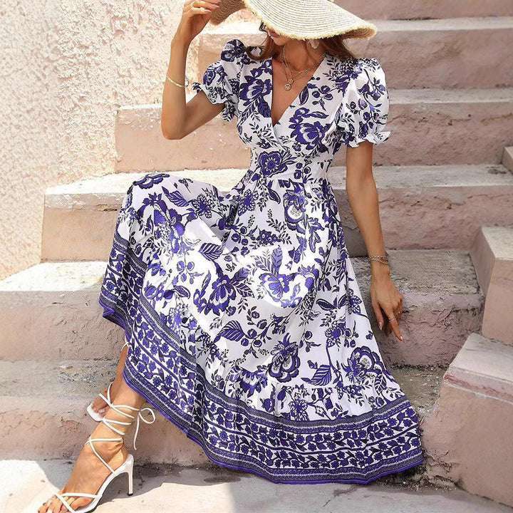 Women’s boho-inspired maxi dress with gathered empire waist, short puff sleeves, and decorative border print Mune Fashion