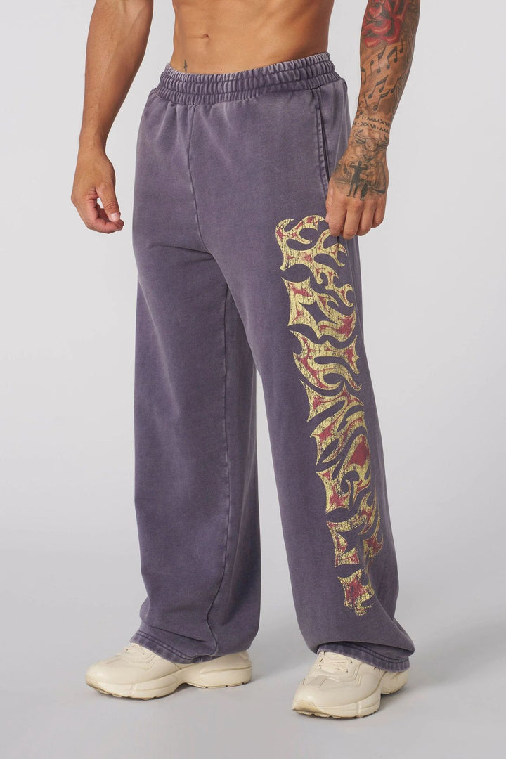 Men's baggy joggers with elastic waistband, side pockets and detailed skull and rose motif Mune Fashion